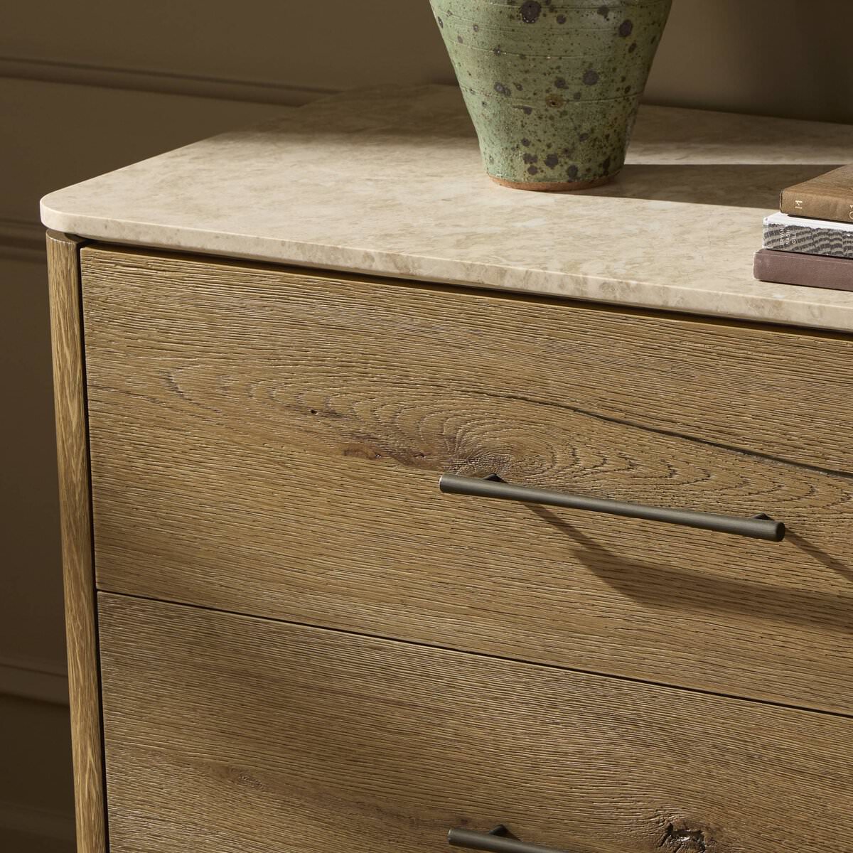 Close up of Four Hands Raleigh 6 Drawer Dresser in Worn Oak Veneer in a bedroom at Addison West