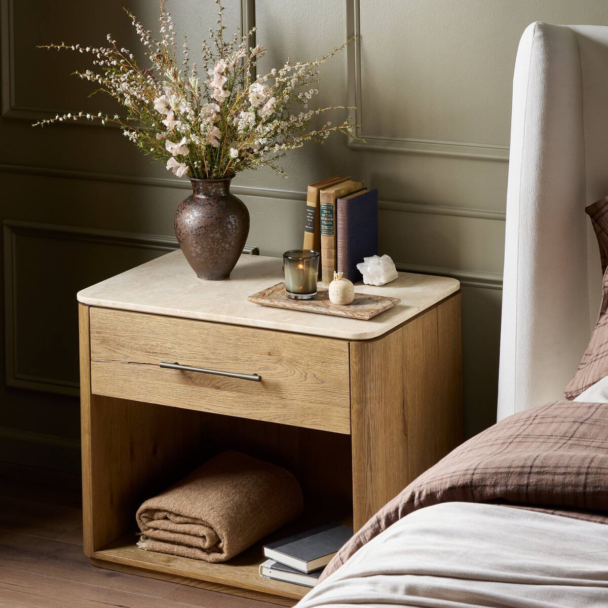 Four Hands Raleigh Nightstand in Cappuccino Marble in a bedroom at Addison West