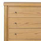 Close up of Four Hands Roark Tall Dresser in Amber Oak on a white background at Addison West