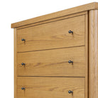 Close up of Four Hands Roark Tall Dresser in Amber Oak on a white background at Addison West