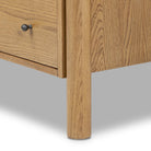 Close up of Four Hands Roark Tall Dresser in Amber Oak on a white background at Addison West