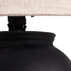 Close up of Four Hands Russo Table Lamp in Aged Black Terracotta on a white background at Addison West
