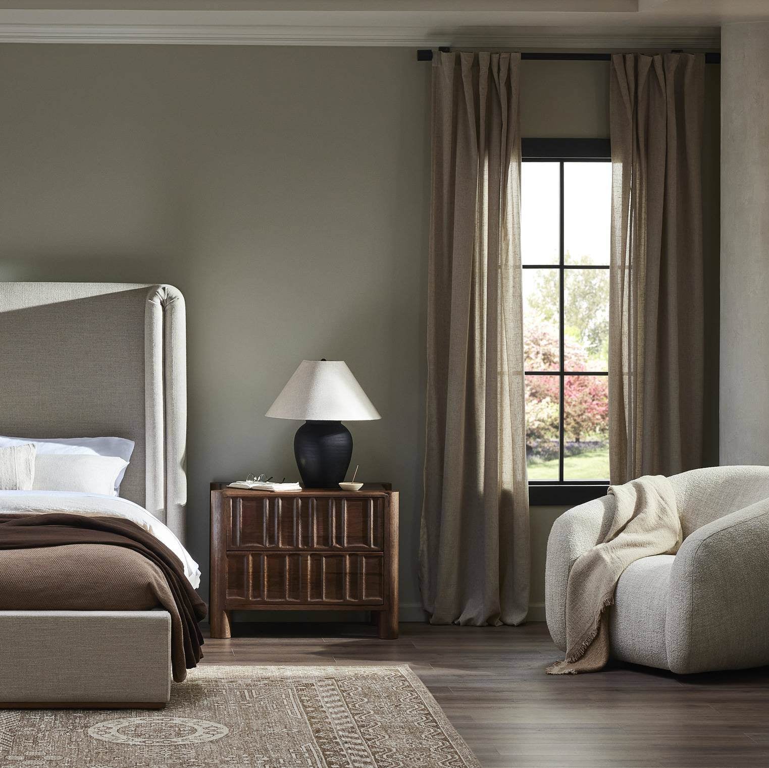 Four Hands Russo Table Lamp in Aged Black Terracotta on a nightstand at Addison West