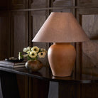 Four Hands Russo Table Lamp in Aged Natural Terracotta on a table at Addison West