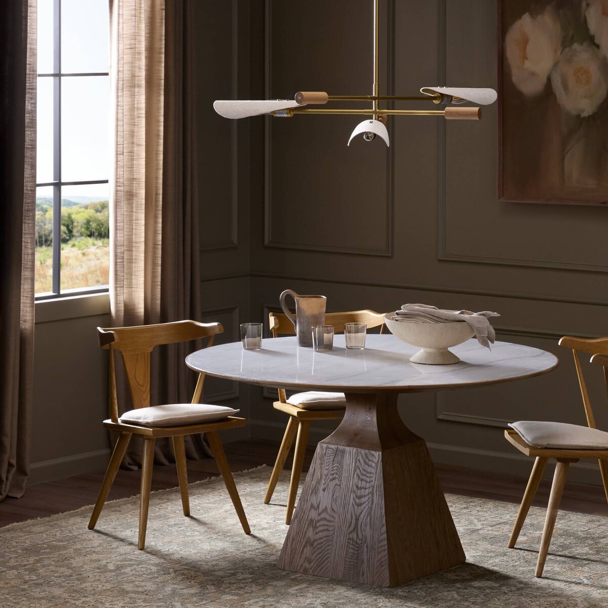Four Hands Sargon Dining Table in Honed White Marble in a dining room at Addison West