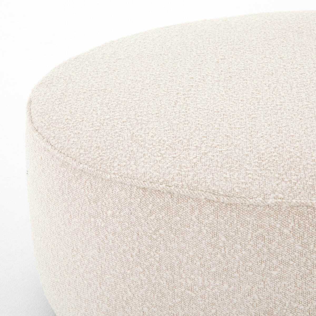 Corner of Four Hands Sinclair Large Round Ottoman in Knoll Natural on a white background at Addison West