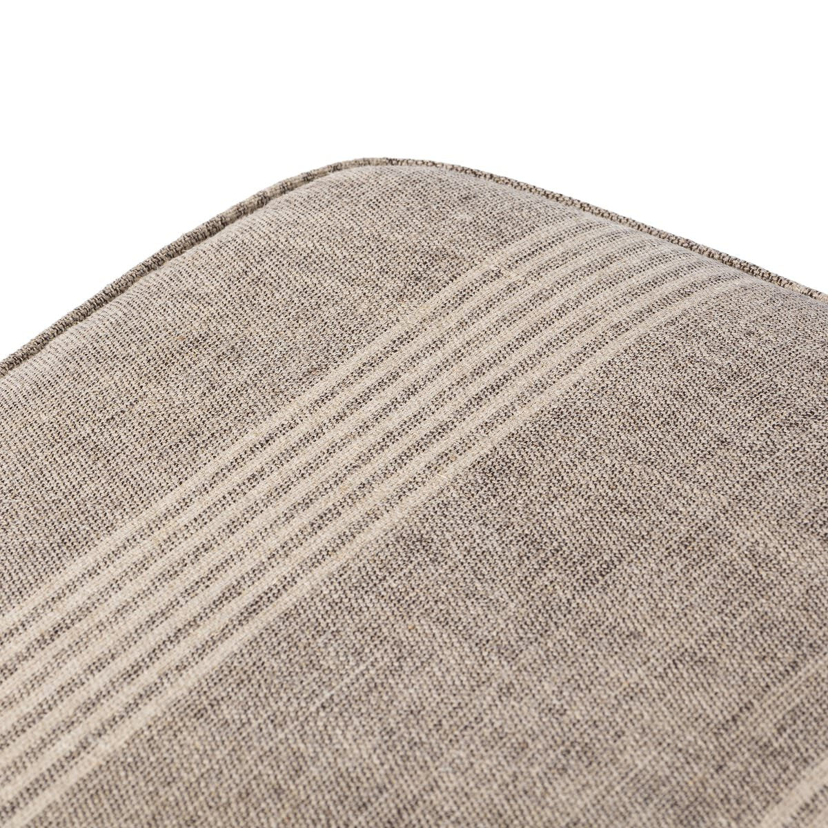 Close up of corner of Four Hands Sinclair Square Ottoman in Manchester Flint on a white background at Addison West