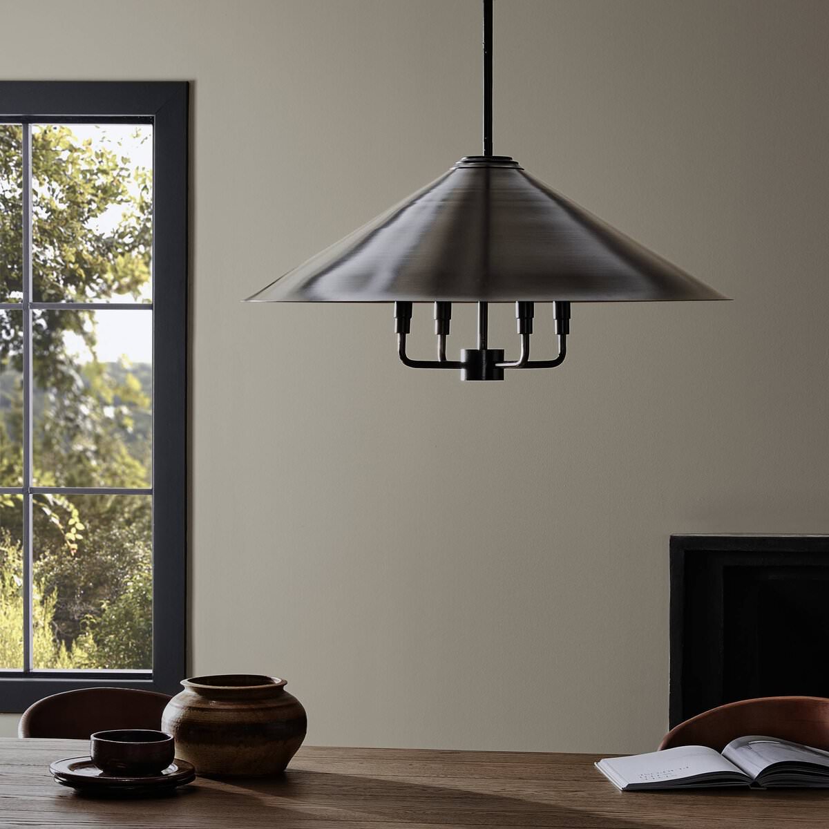 Four Hands Siriano Chandelier in Antique Brass Iron in a modern dining room