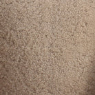 Close up of Four Hands Topanga Swivel Chair in Beige Shearling on a white background at Addison West
