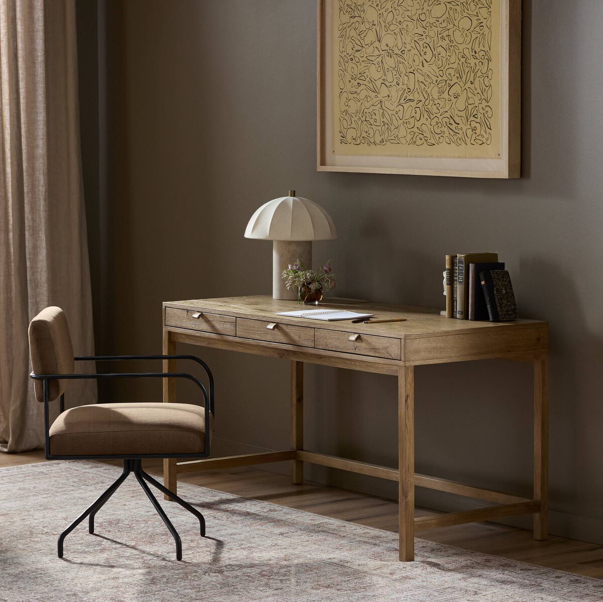 Four Hands Tula Writing Desk in Worn Oak Veneer in an office with green walls at Addison West