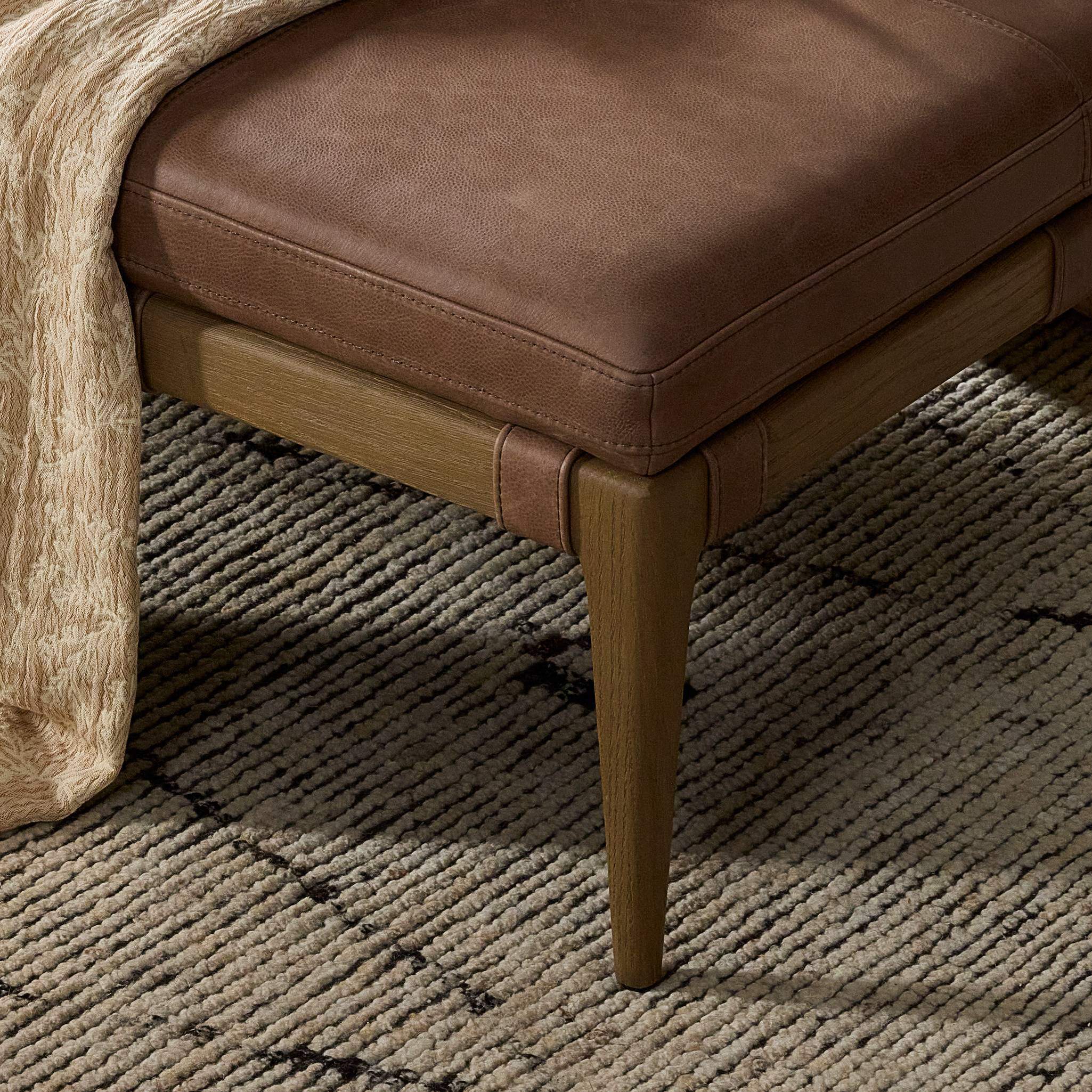 Four Hands Ulrick Ottoman Palermo Cigar in living room at Addison West.