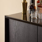 Close up of Four Hands Vinco Sideboard in Black Onyx Lacquer in a living room at Addison West
