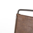 Close up of Four Hands Wharton Bar Stool in Distressed Brown on a white background at Addison West