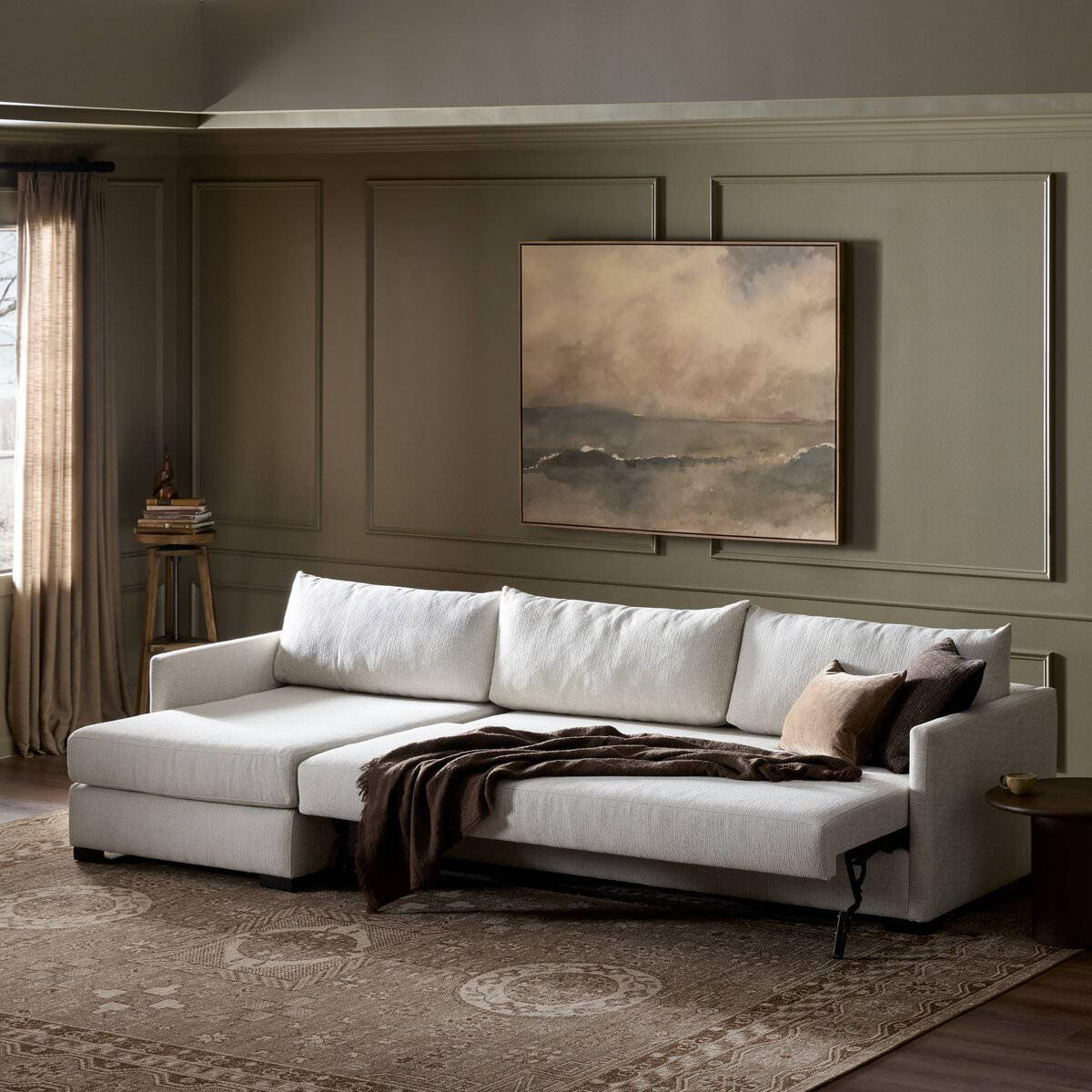 Four Hands Wickham 2-Piece Sleeper Sectional in Alameda Snow in a green living room at Addison West