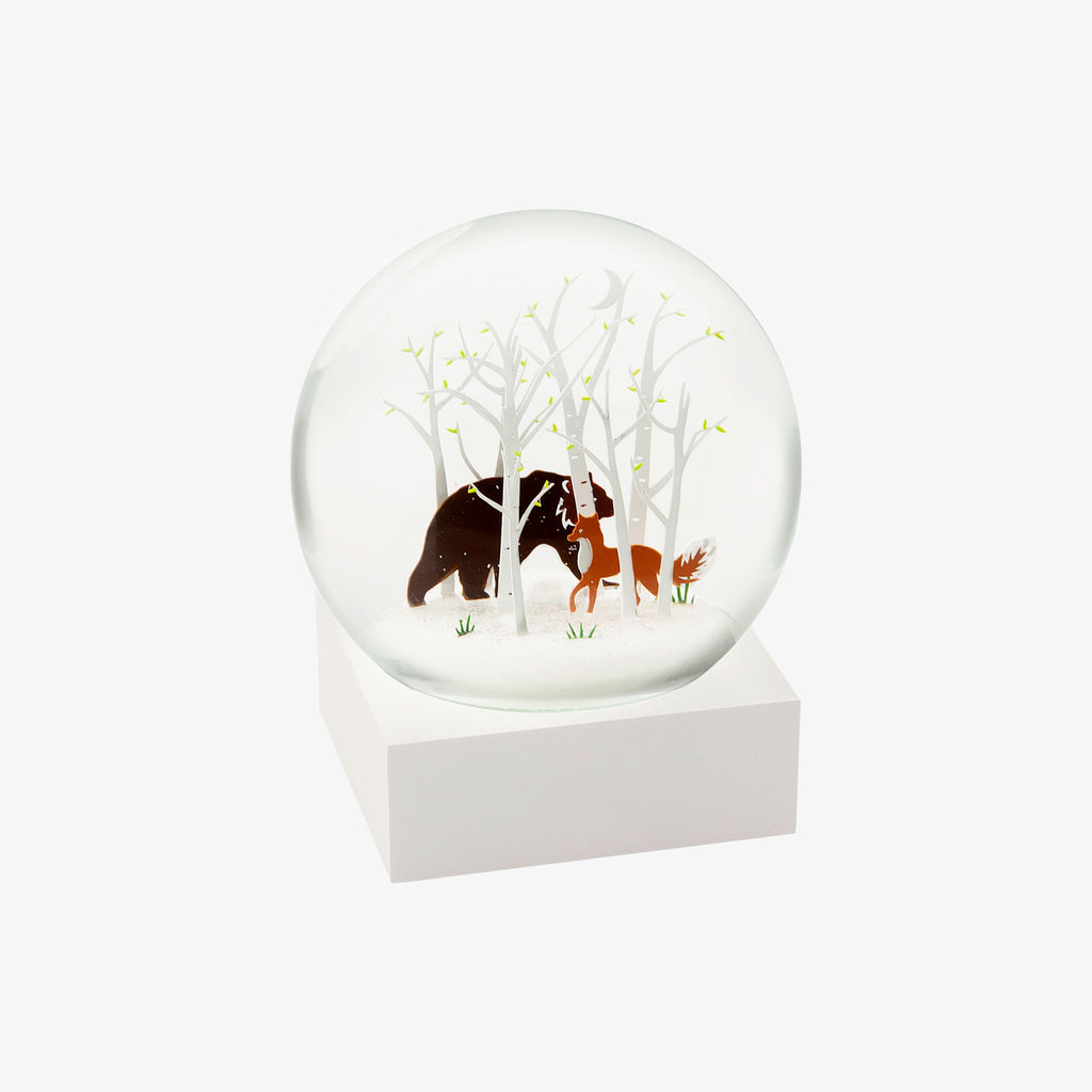 Snow globe with fox and bear and white trees on a white background
