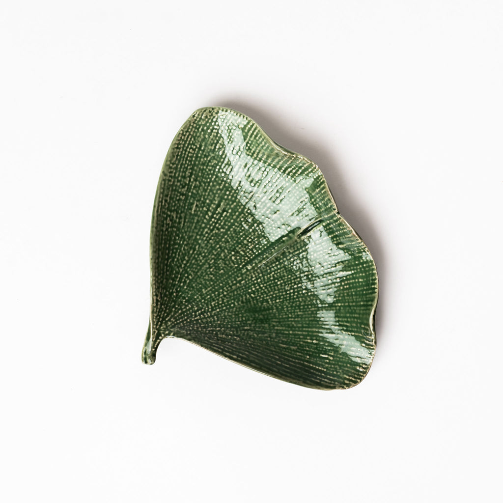 Small green Ginko leaf plate on a white background
