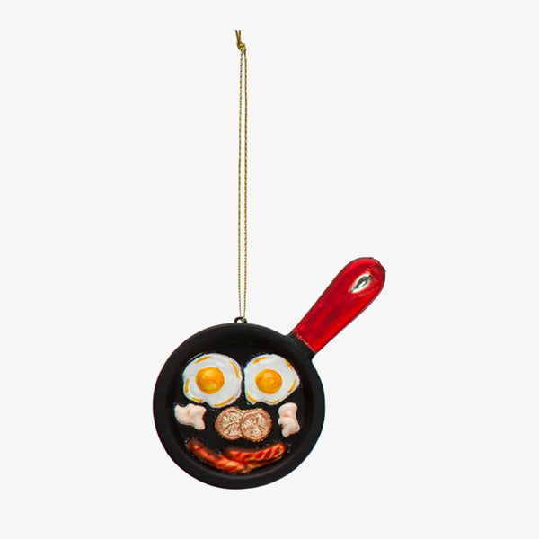 Cast Iron Breakfast Skillet Ornament with red handle and eggs and bacon a white background
