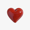 Small red glass heart on a white background