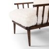 Four Hands Graham Chair with spindle back and shearling cushions on a white background