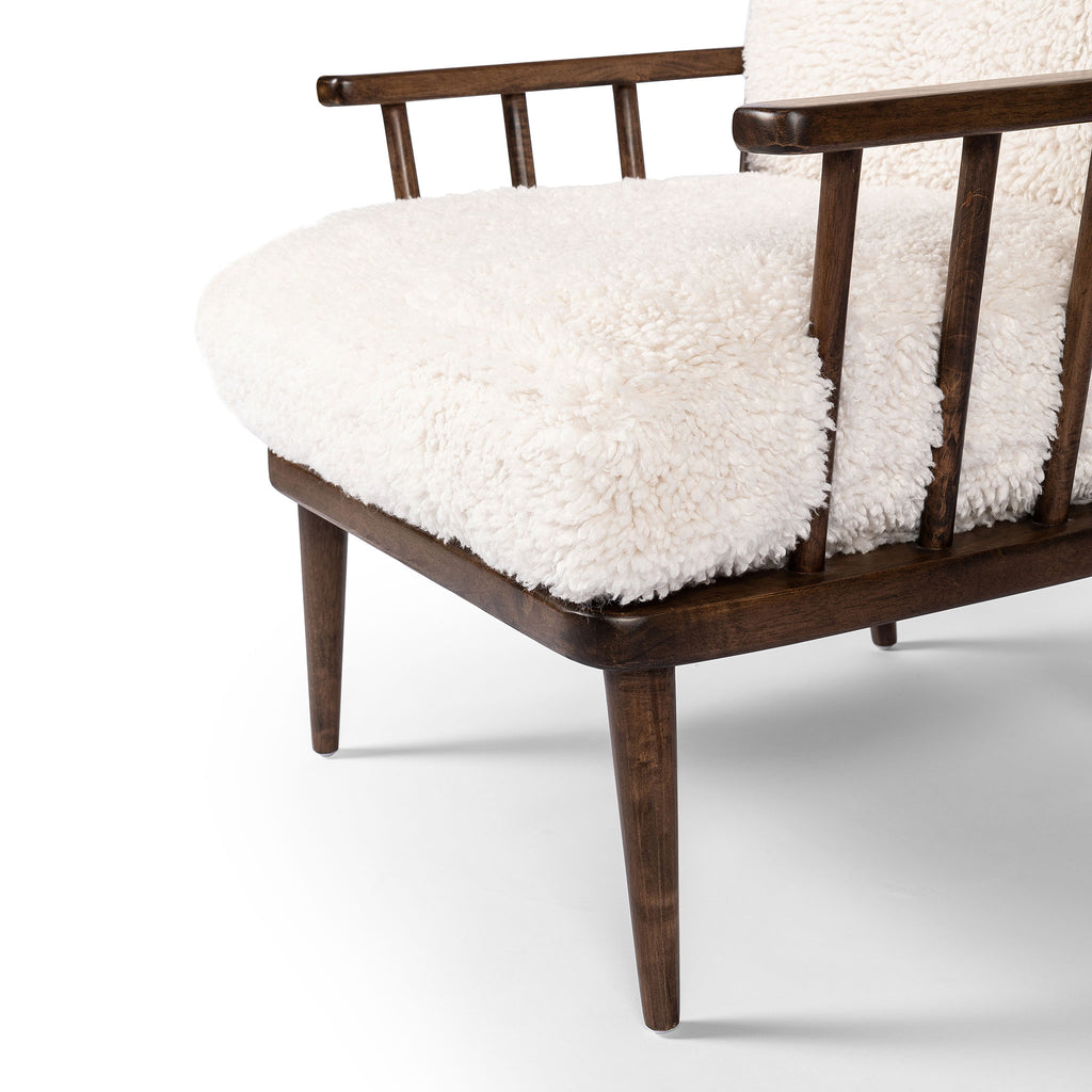 Four Hands Graham Chair with spindle back and shearling cushions on a white background