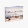 Puzzle by Gray Malin: The Winter Holiday with skis in snow and view of mountains on a white background