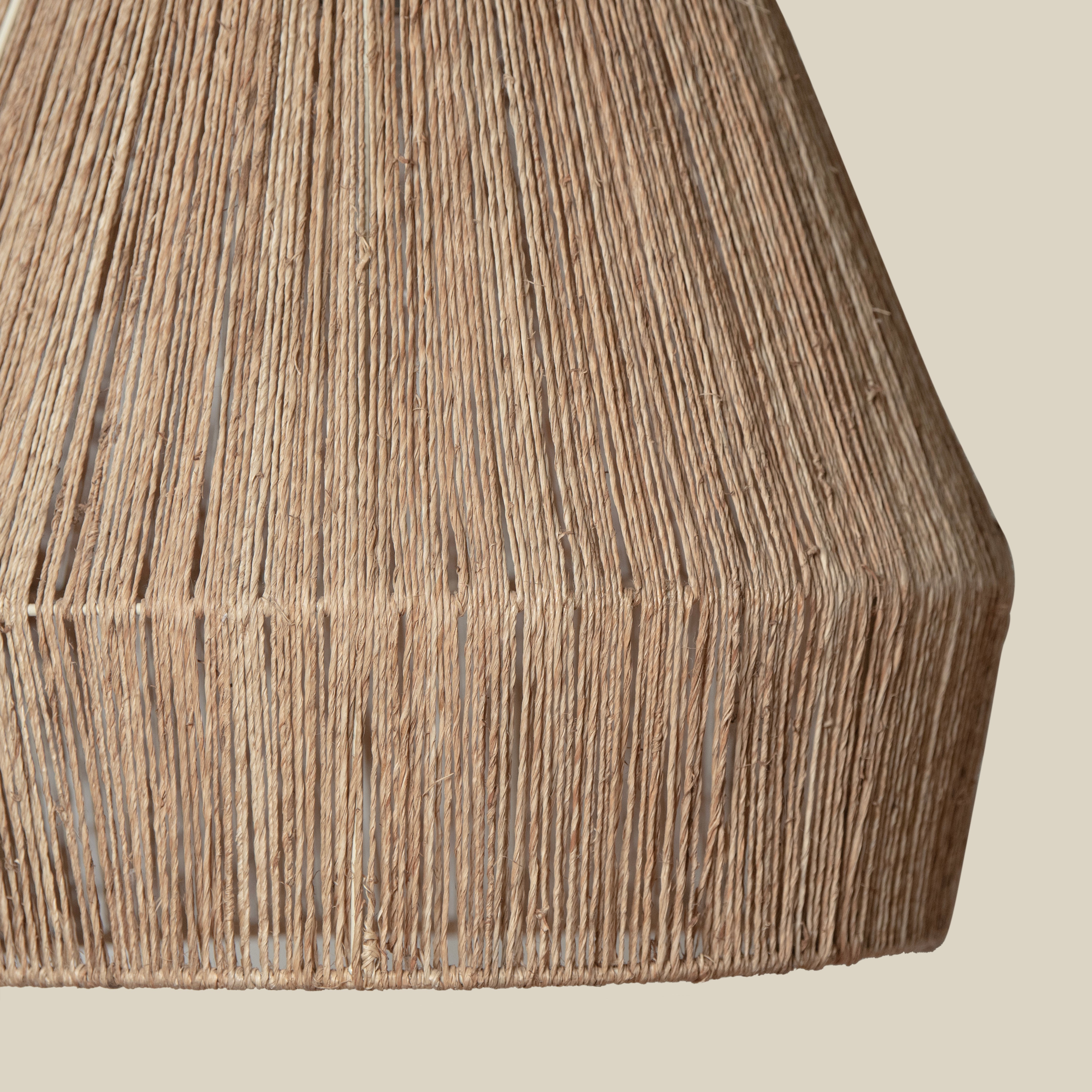 Close up of Collins Jute Pendant on a beige background at Addison West