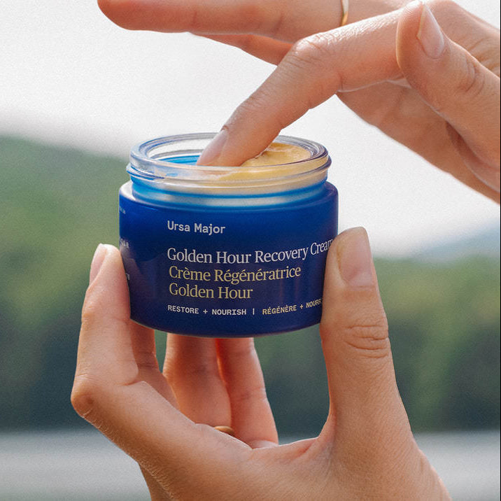 Ursa Major golden hour recovery cream held by a model at Addison West