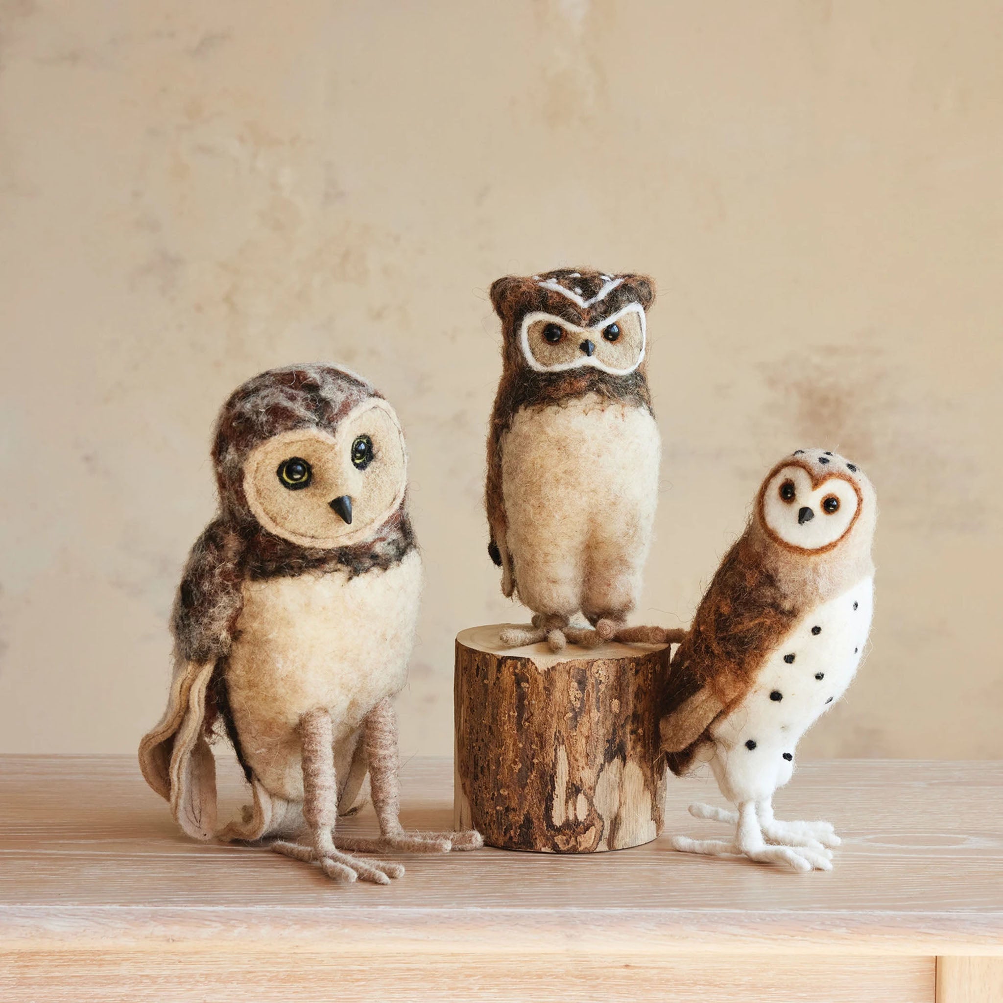 Handmade Wool Felt Owls on a beige background at Addison West