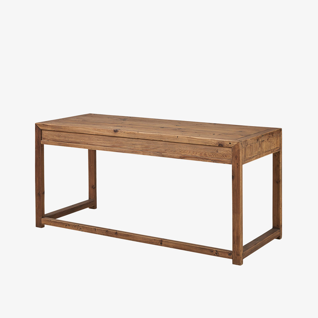 Pine wood writing desk with three drawers on a white background