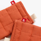 Hedley & Bennett Paprika Oven Mitts on plain background at Addison West.