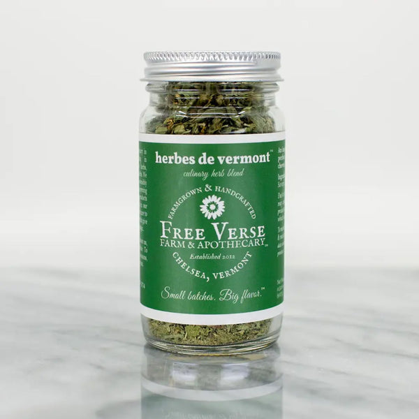 Free verse farm Vermont made herbes de vermont in glass jar with green label on a marble surface