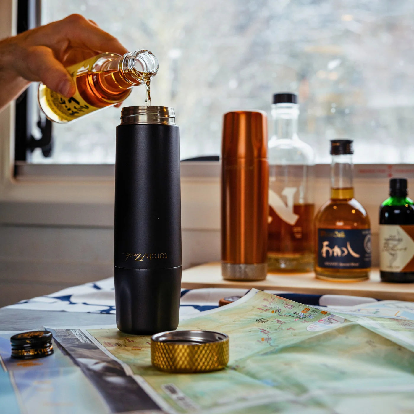 High Camp 9 oz. Torch Flask in Onyx on a table at Addison West