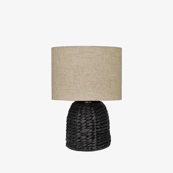 Black woven lamp with linen shade on a white background