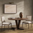 Four Hands Cobain Round 60" Dining Table in Reclaimed Mango in a modern dining room