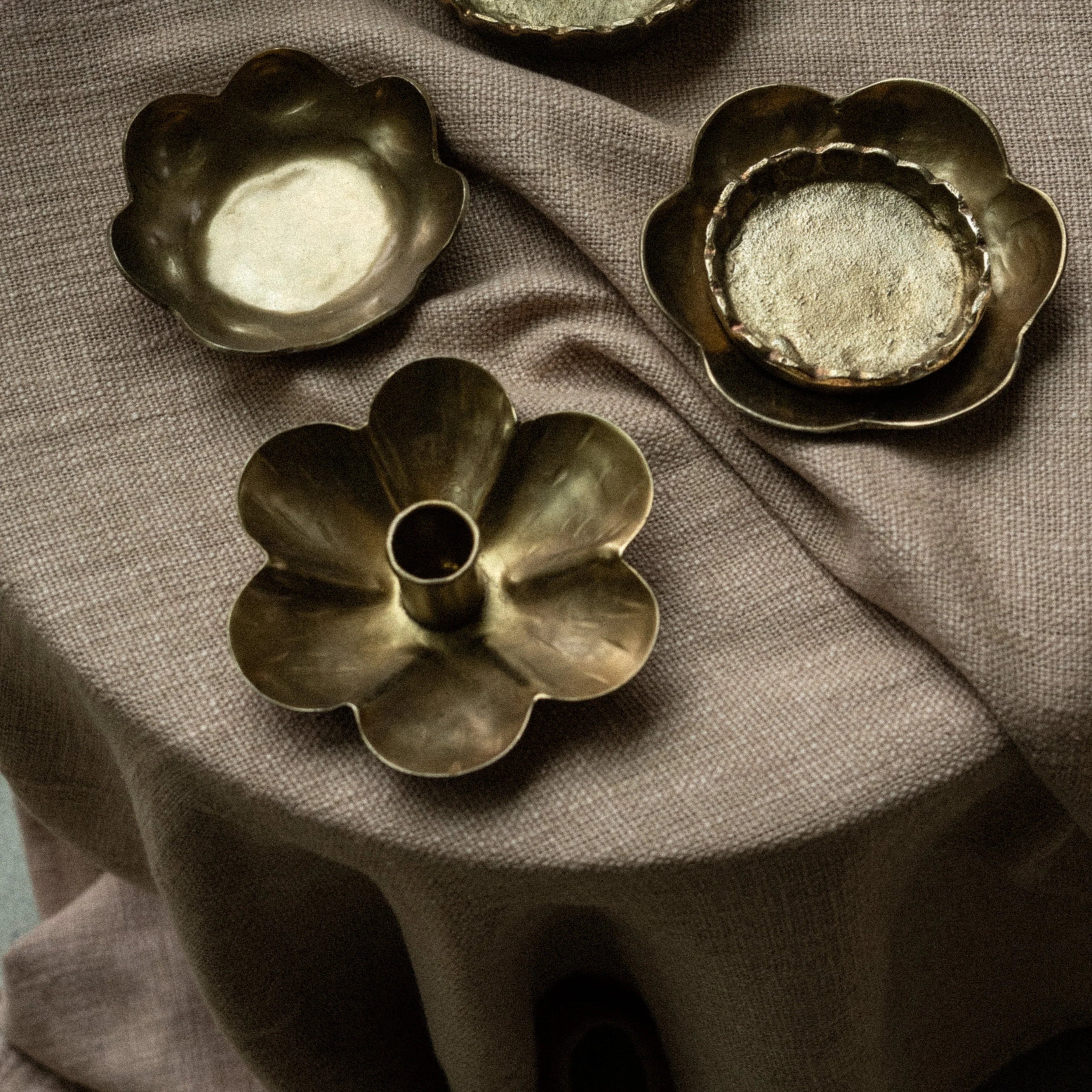 Forged Flower Candle Holder on a brown table at Addison West