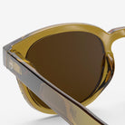 Izipizi #C Golden Green Sunglasses on a white background at Addison West