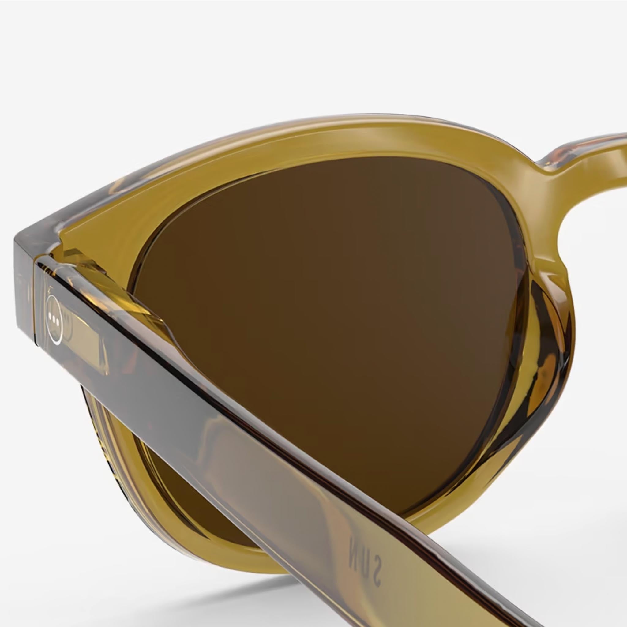 Izipizi #C Golden Green Sunglasses on a white background at Addison West