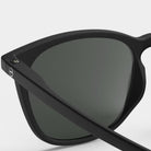Izipizi #E Black Sunglasses on a white background at Addison West