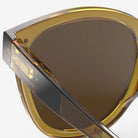 Izipizi #N Golden Green Sunglasses on a white background at Addison West