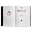 Julia Child's Mastering the Art of French Cooking Leather Bound Edition on white background at Addison West.