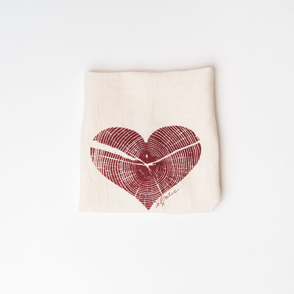 Creme colored tea towel with heart on a white background