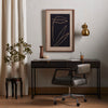Four Hands Kelby Writing Desk in Carved Vintage Brown in an office with beige walls and linen curtain