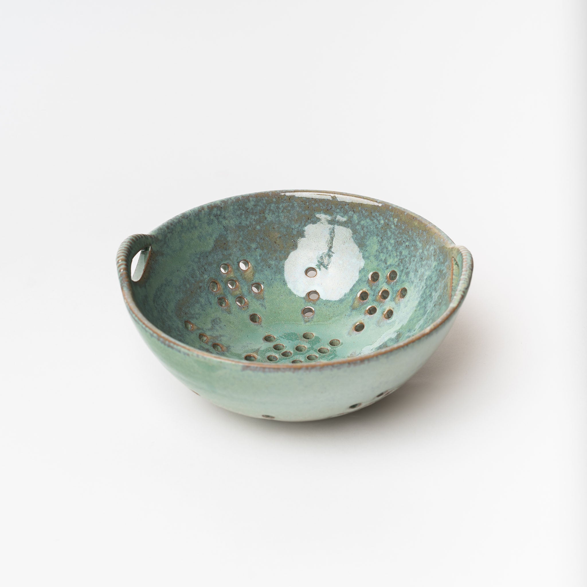 Blue Green glazed berry bowl on a white background