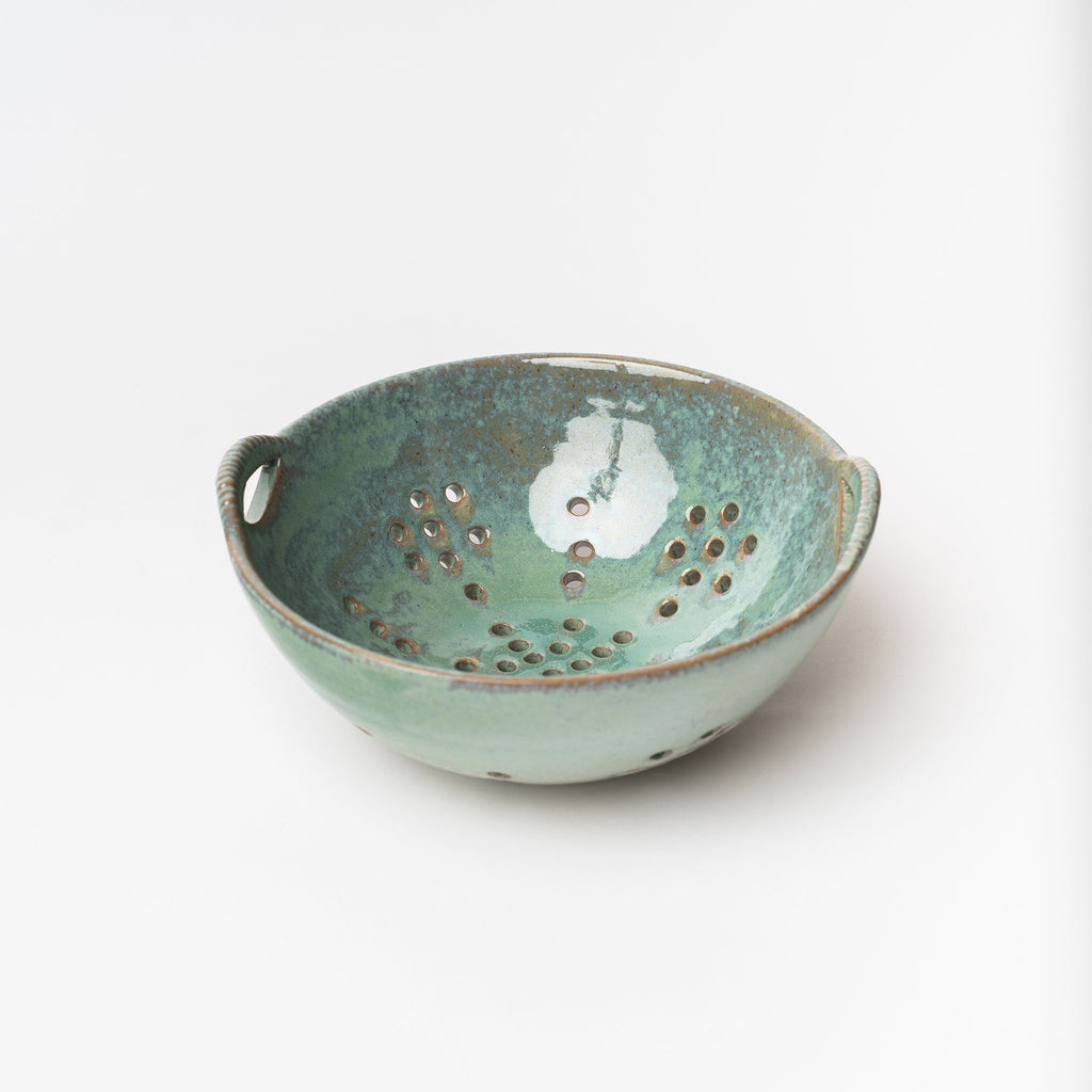 Blue Green glazed berry bowl on a white background