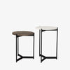 Round nesting side tables with black frames on a white background