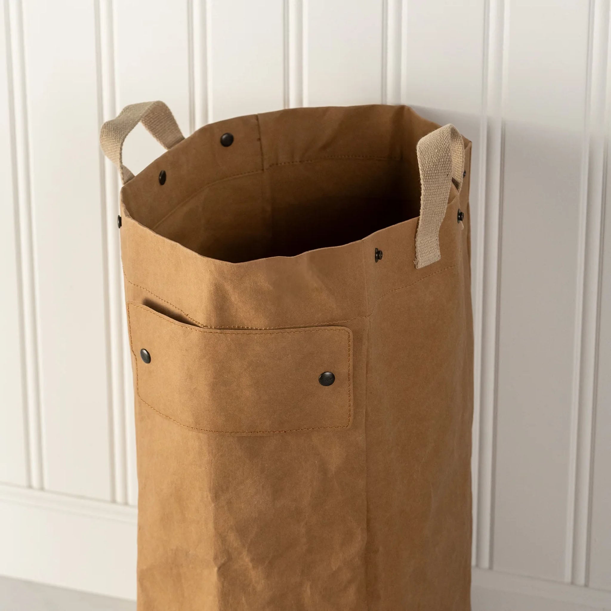 Close up of Uashmama Laundry Hamper Bag in Avana on a white background at Addison West