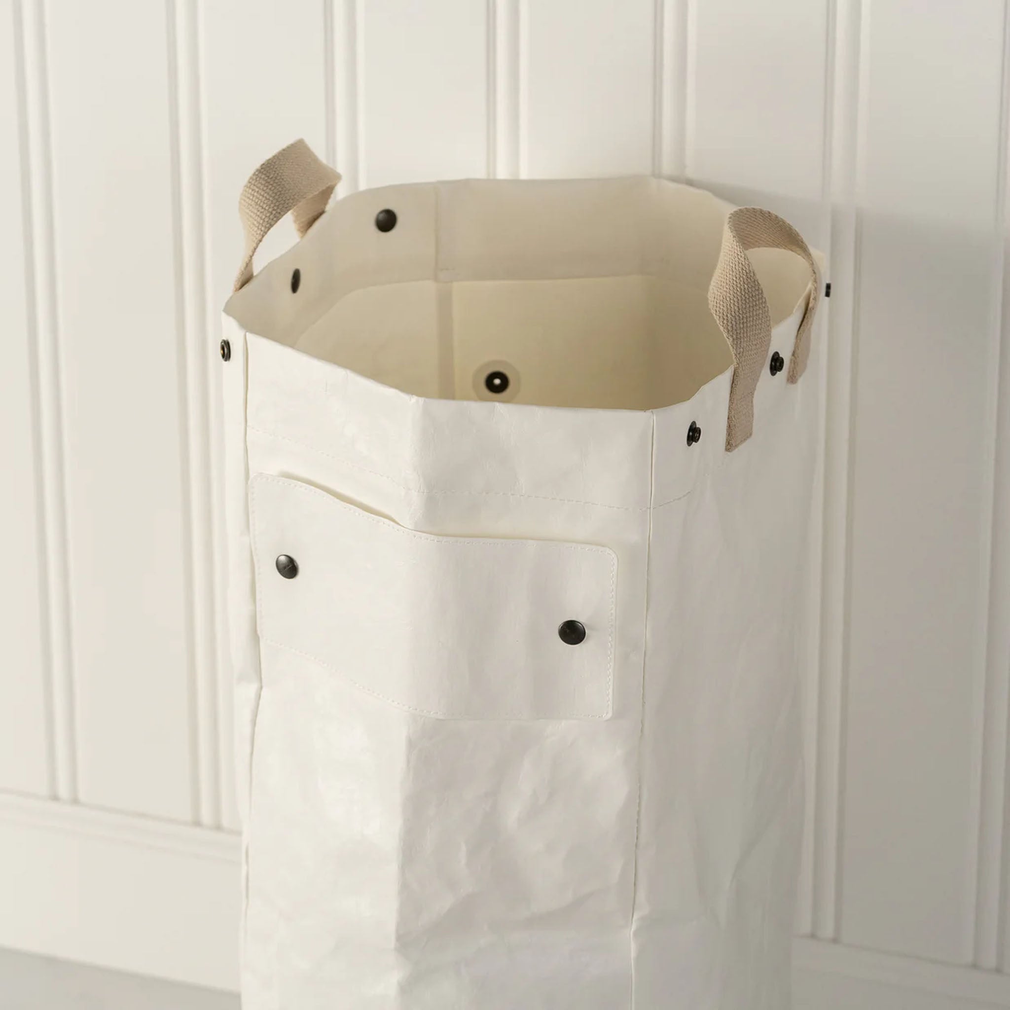 Close up of Uashmama Laundry Hamper Bag in a laundry room at Addison West