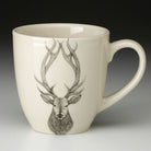 Laura Zindel Red Stag Mug with white interior on grey background.