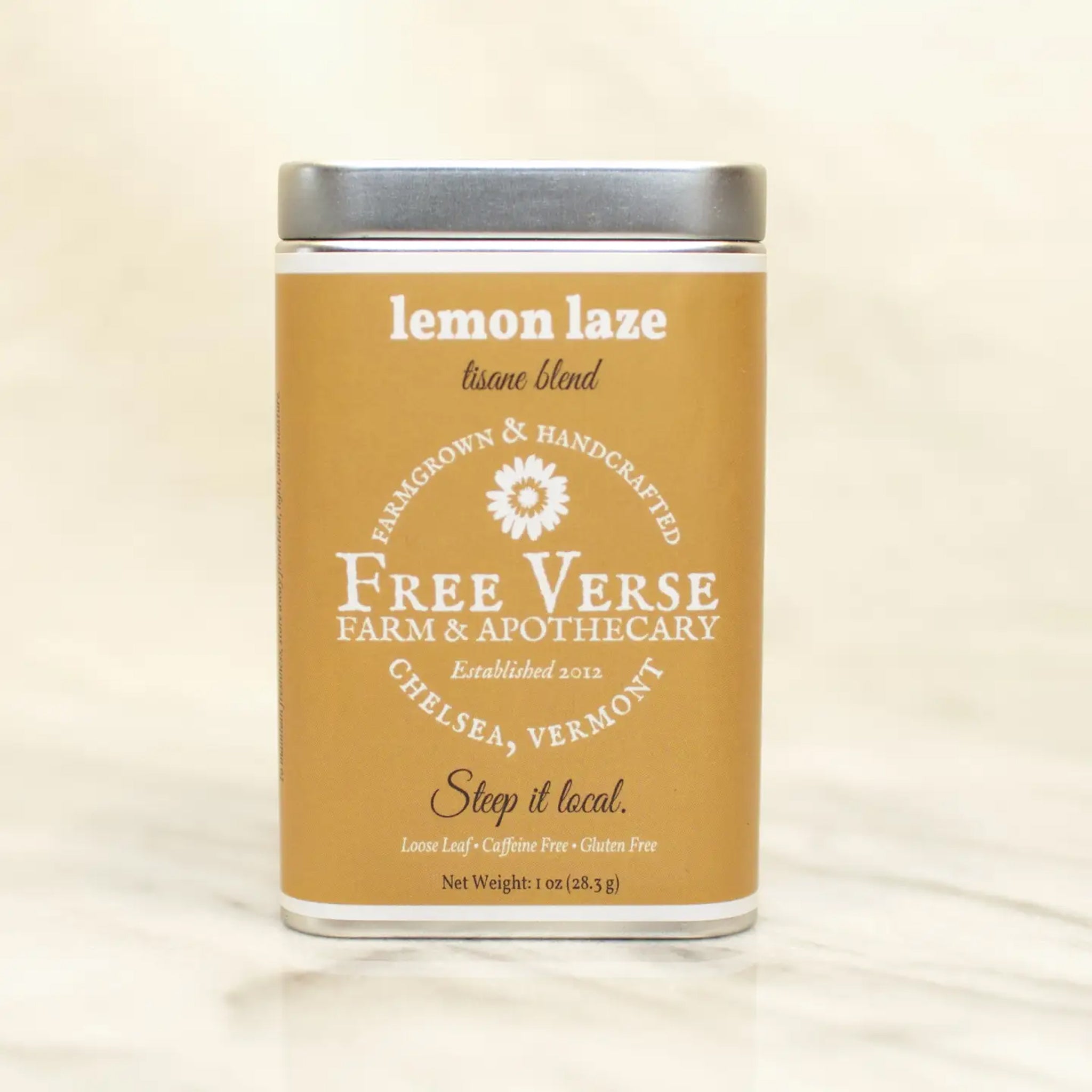 Tin of Free Verse Apothecary Lemon Laze Loose Leaf Herbal Tea Blend on a neutral background