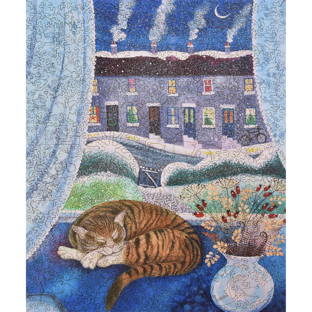 Liberty Puzzles Cosy Cat puzzle with cat on blue window seat and small row of houses behind with smoke coming from chimneys